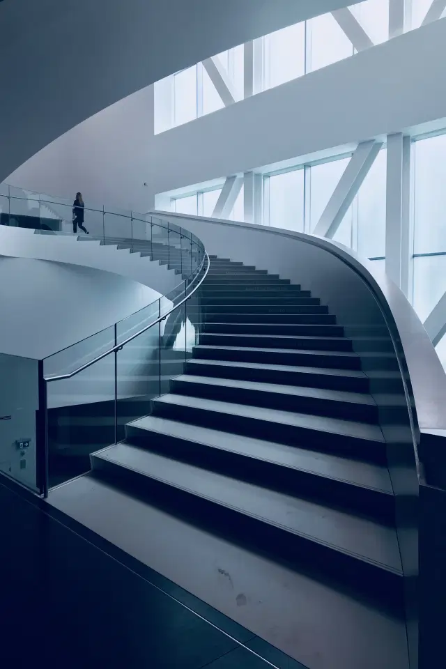 A modern architectural staircase symbolizing the structured business approach and framework for success offered by Greenfields.