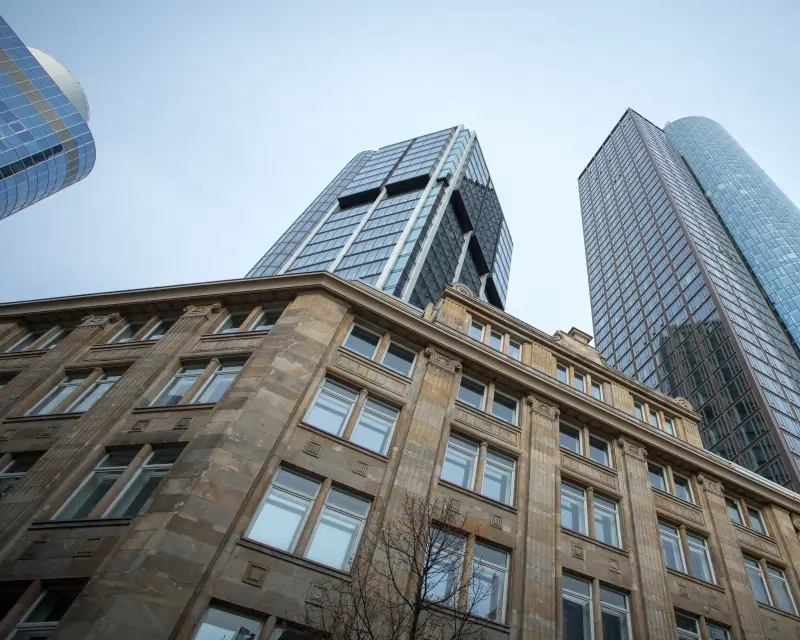 Low-angle view of classic and modern architecture in the Frankfurt financial district, representing corporate service in Germany