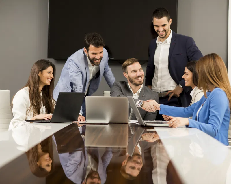 A team of professionals collaborating, representing Greenfields' expert payroll services for businesses in Germany.