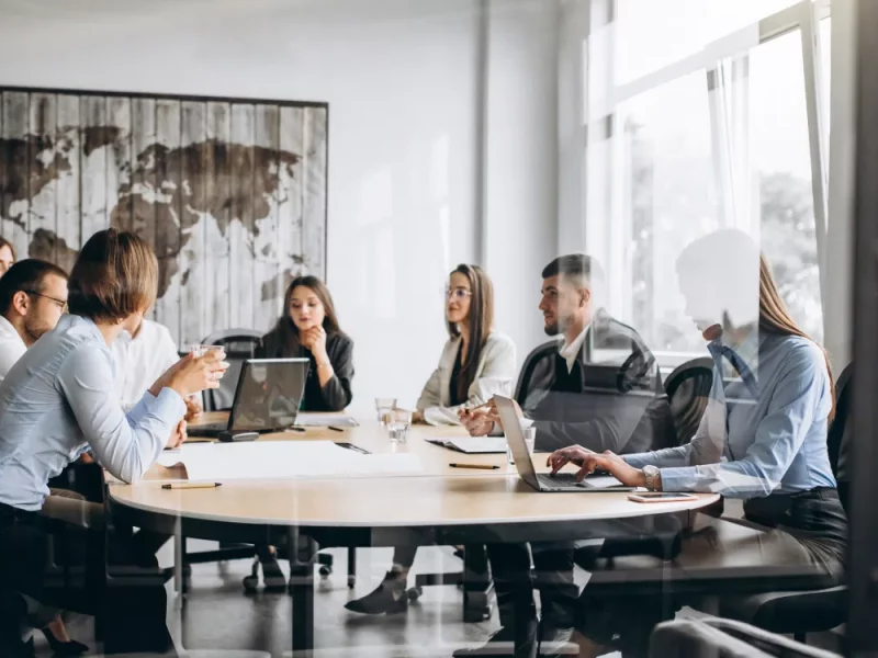 A diverse international team in a modern office, representing Greenfields' corporate services for Multi-National Corporations.