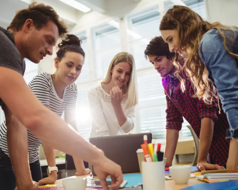 A creative team collaborating, representing Greenfields' corporate services for start-ups launching their business.